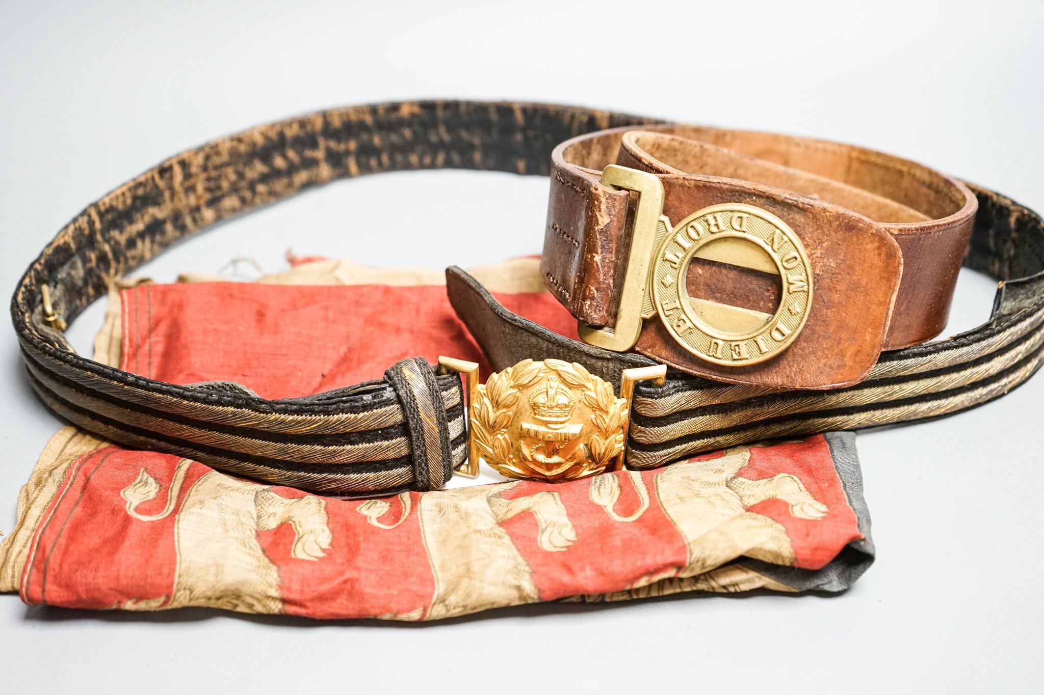 A Royal Naval gilt brass mounted officers belt and an Edwardian Dieu et mon droit belt and a Victorian printed flag